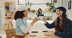 Girl, friends and cheers in coffee shop for social meeting, connection and happy bonding at lunch date. Smile, brunch and women toast in cafe together with morning drinks, chat and reunion at table	