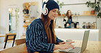 Coffee shop, laptop and woman with headphones for remote work, typing email and networking. University, restaurant and person working on computer in cafe for online learning, research and education