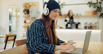 Buy stock photo Coffee shop, laptop and woman with headphones for remote work, typing email and networking. University, restaurant and person working on computer in cafe for online learning, research and education