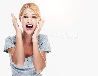 Buy stock photo Studio portrait of a young woman looking afraid against a white background