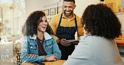 Buy stock photo Coffee shop, women and waiter with tablet, conversation and customer service order at restaurant. Barista, staff and happy girl friends with smile and chat at diner with employee helping with tech