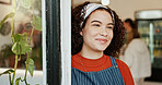 Smile, thinking and woman at coffee shop entrance for opening with friendly idea of hospitality. Cafe, door and plannijng with happy restaurant owner or waitress at store for greeting or service
