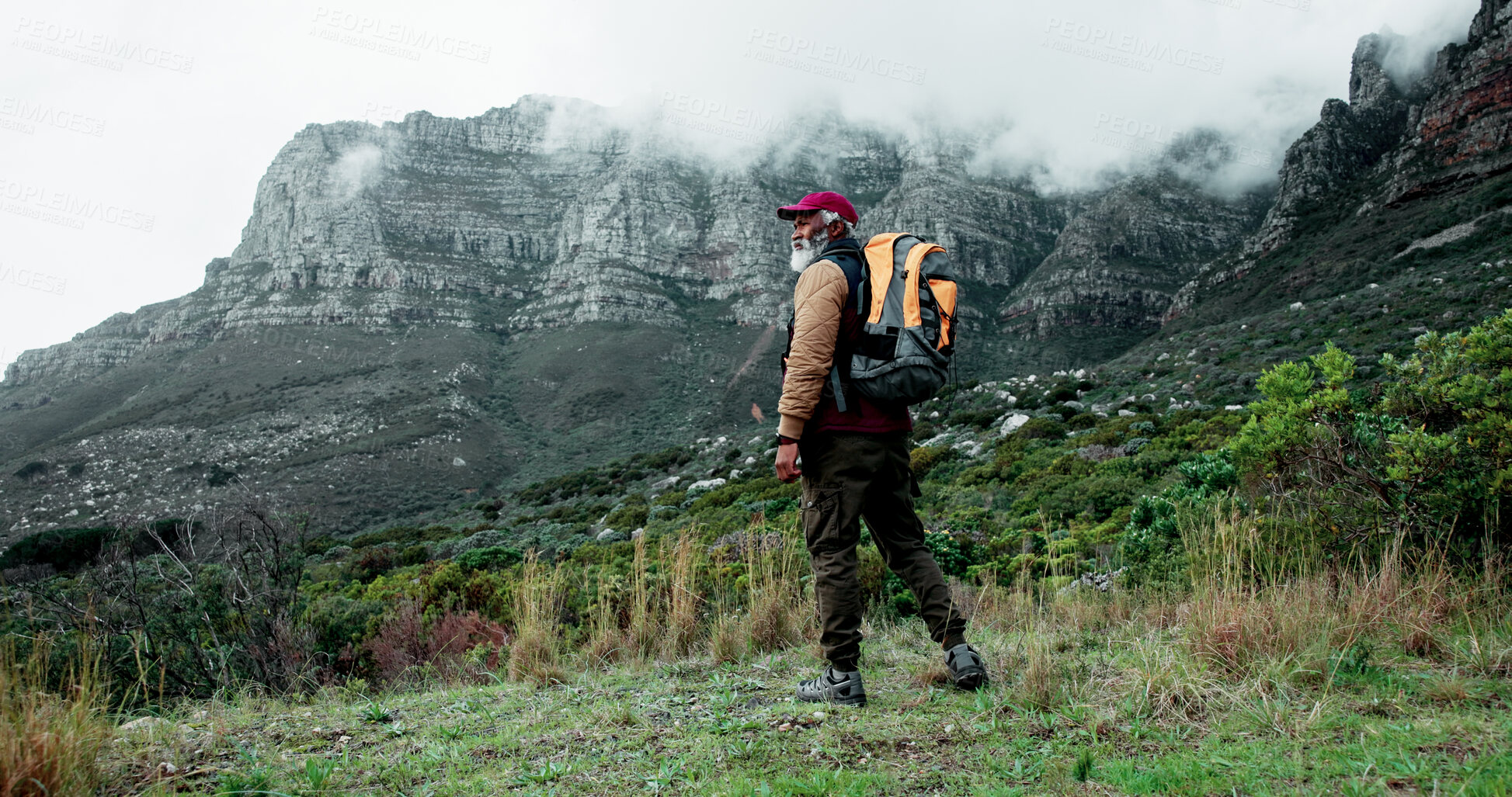 Buy stock photo Senior, mountain or black man hiking in nature adventure or journey in woods or outdoor travel. View, forest and person thinking on trail walking for holiday, break or trekking to explore in France