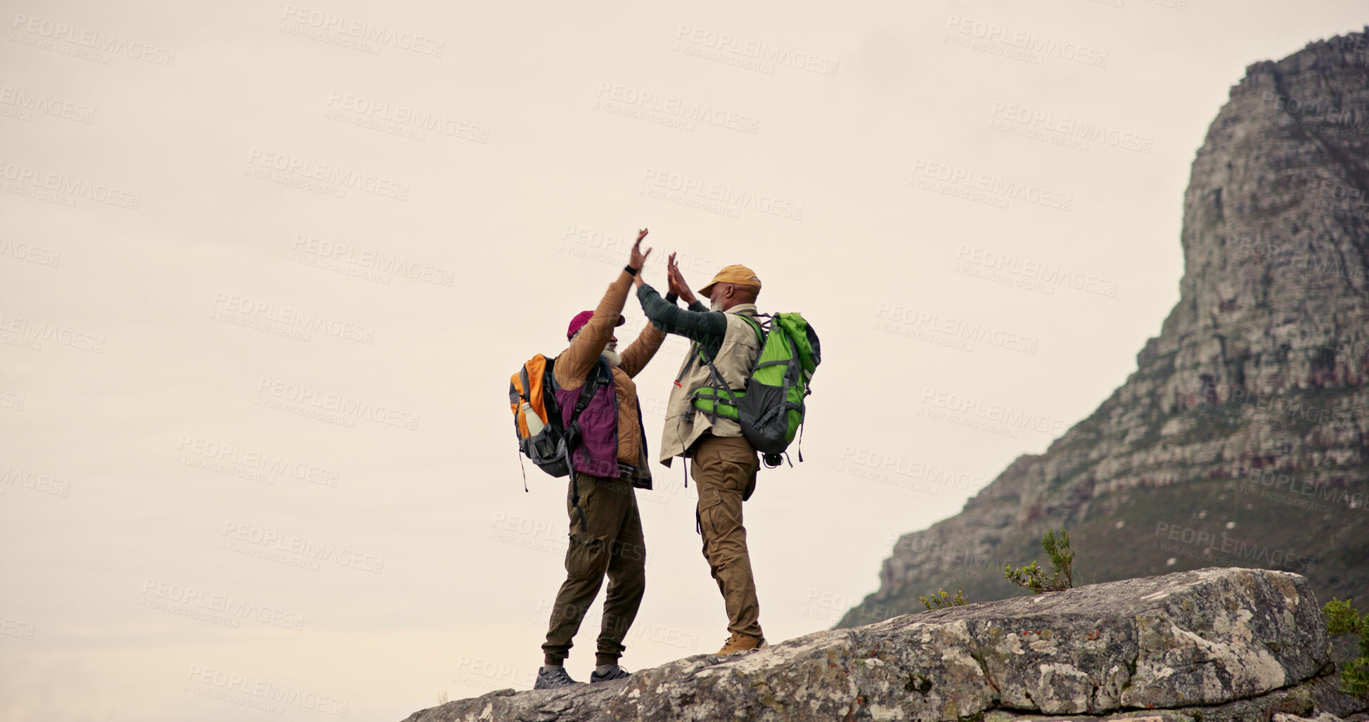 Buy stock photo Hiking, high five and men on mountain cliff with backpack for adventure, trekking and fitness. Travel, nature and happy people mockup for wellness and exercise on holiday, journey and vacation