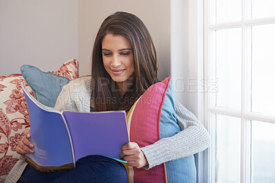 Buy stock photo Woman, beauty magazine or reading book in home for skincare tips, knowledge or press news to relax. Female person, smile or information for learning, fun gossip story or resting on chair on weekend