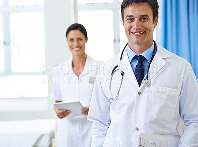 Buy stock photo Portrait, doctor and man with smile, nurse and happy in hospital, proud or expert. Clinic, medical professional and confidence of person, healthcare and lab coat for employee with clipboard or tablet