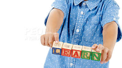 Buy stock photo Learning, studio and hands of kid with building blocks for playing, education and child development. Creative, childhood and isolated toddler with school toys for spelling games on white background