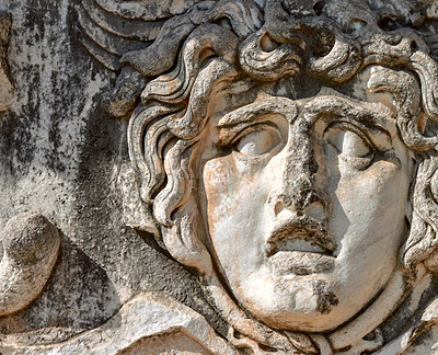 Buy stock photo Ancient, face sculpture and architecture as site in Greece as tourist destination for historic education. Traditional building, culture and carved stone or vintage art for tourism and holiday