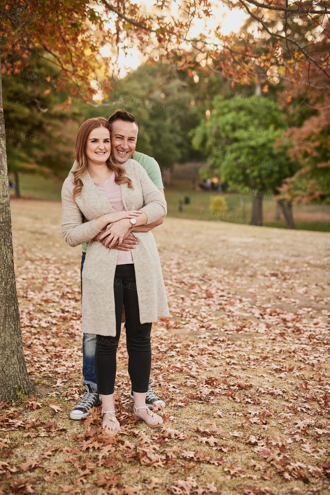 Buy stock photo Outdoor, couple and portrait with hug for relationship, connection and bonding together on date. Happy people, woman and man with love for embrace, affection and commitment with smile in Canada