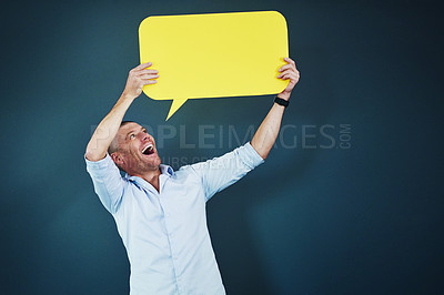 Buy stock photo Business man, speech bubble and happy in studio with mockup space for opinion, deal or sale by blue background. Person, poster and yellow board for news, announcement and excited for social media