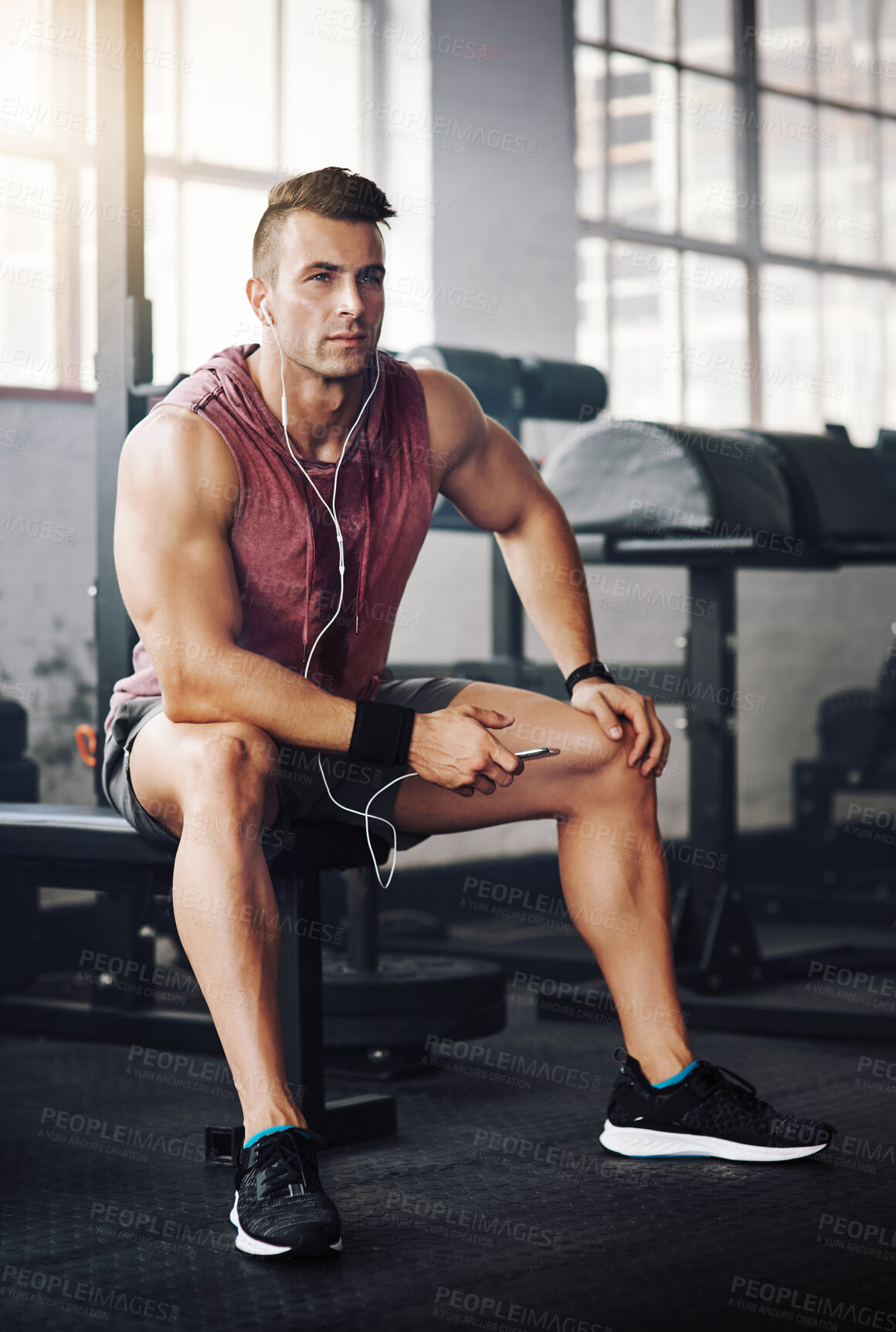 Buy stock photo Man, phone and thinking in gym for relax, exercise and playlist with radio for motivation. Training, mobile and male bodybuilder on break from fitness, workout and earphones for listening to podcast