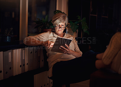 Buy stock photo Mature woman, reading and relax with tablet on sofa for notification, web blog or comfortable in living room. Online, night and person with glasses for information, email or news article in home