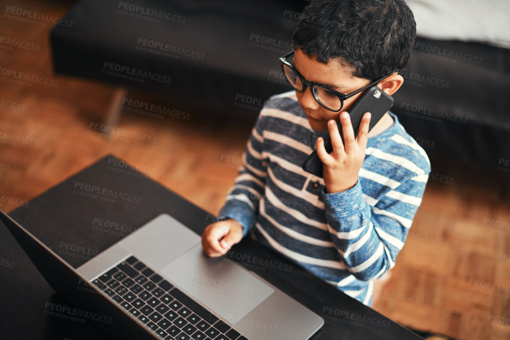 Buy stock photo Phone call, child and talking in home with laptop for story, game and learning on internet in living room. Mobile, contact and boy in conversation for communication, education and listening to play