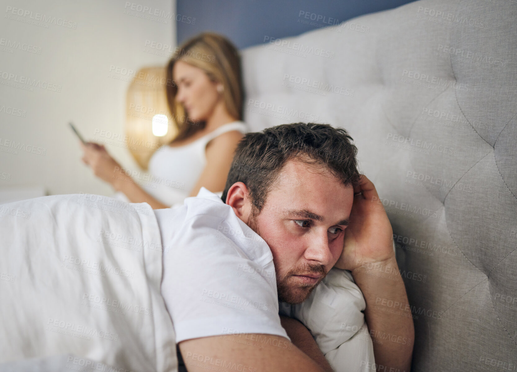 Buy stock photo Phone, thinking and man in bed with cheating wife, infidelity or affair in online chat at home with stress. Marriage conflict, divorce or couple on mobile app with betrayal or upset husband in house