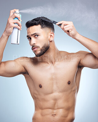 Buy stock photo Hair spray, comb and man in studio for grooming, hairstyle or morning routine on white background. Salon, bottle and hand of model with product for confidence, scalp wellness or shampoo treatment