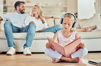 Buy stock photo Child, reading book and headphones in home for music with audio playlist, fairytale and learning. Young girl, literature and listening to radio in lounge for fantasy story, podcast and relax in house