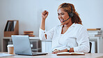 Happy and cheerful mixed race female call center agent cheering in support and working on a laptop in an office at work. Confident hispanic female boss smiling while celebrating a victory on a call