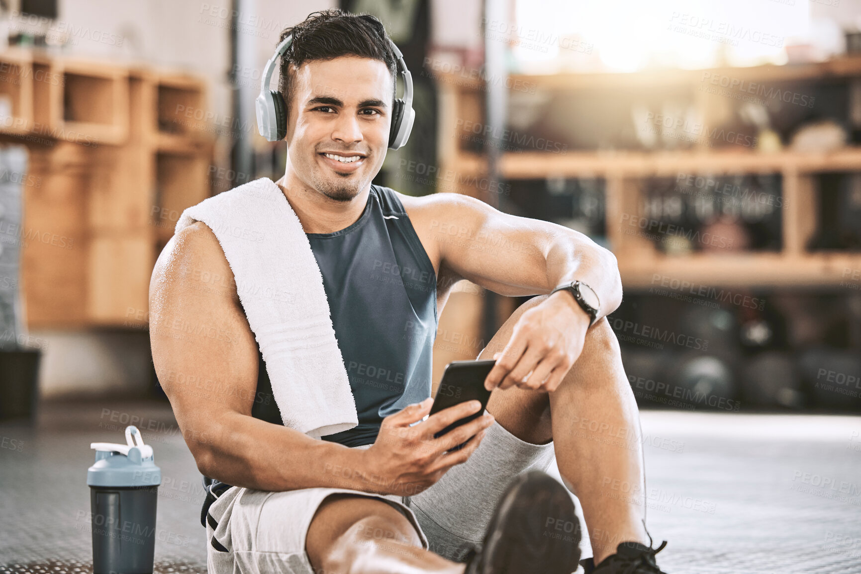 Buy stock photo Fitness, man and portrait with smartphone, headphones for music and exercise tracker, app and workout progress. Male person, happy and gym with training playlist, audio and online for cardio tips.