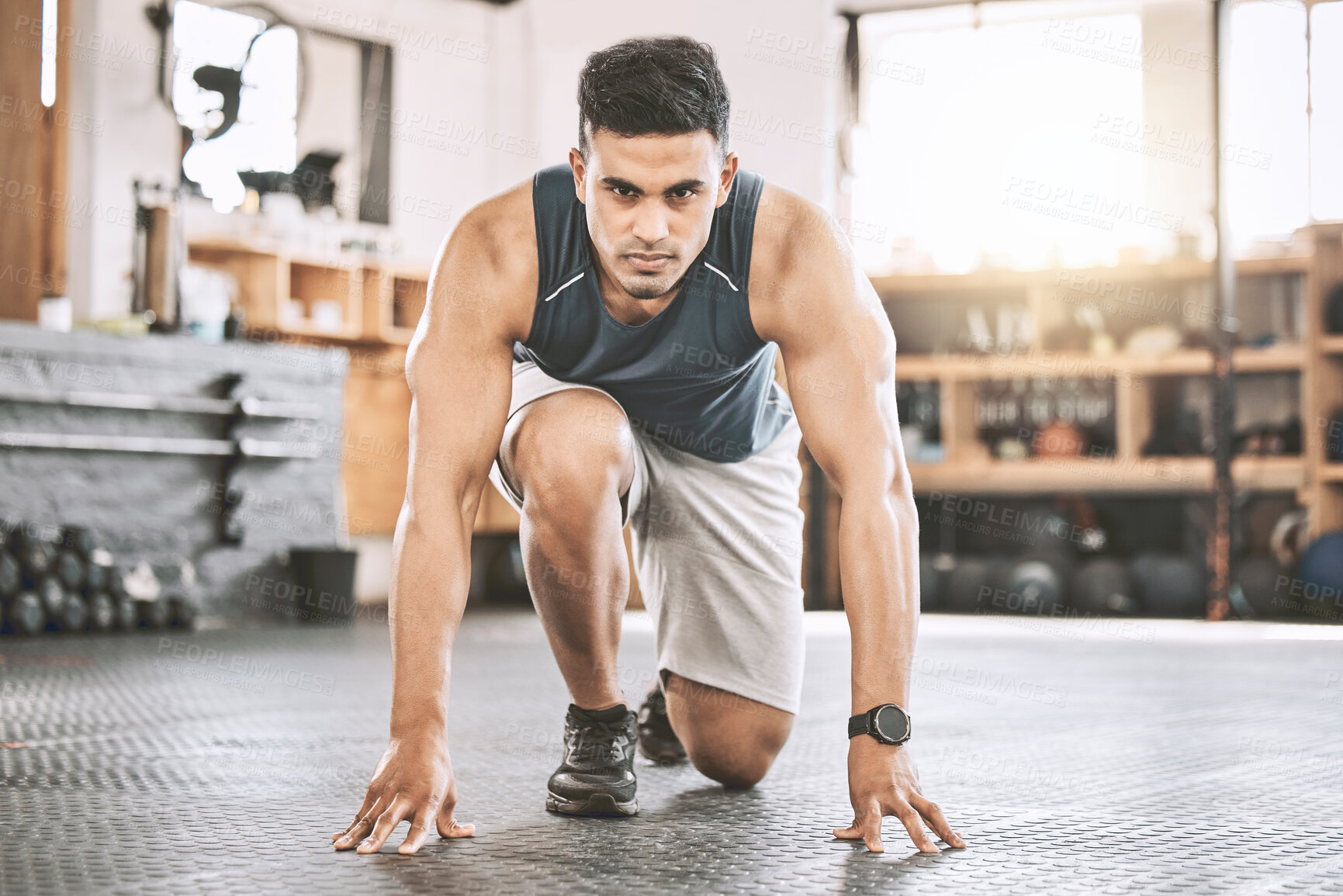 Buy stock photo Fitness, portrait and man prepare to start training, exercise and running at sport gym for body health. Determined, crouch and athlete ready for workout, race and physical challenge with confidence