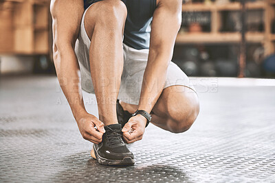 Buy stock photo Hands, sneakers and athlete tie laces in gym with workout, fitness or exercise for bodybuilding. Shoes, activity and feet of person preparing for training, health or weightloss in sports center.