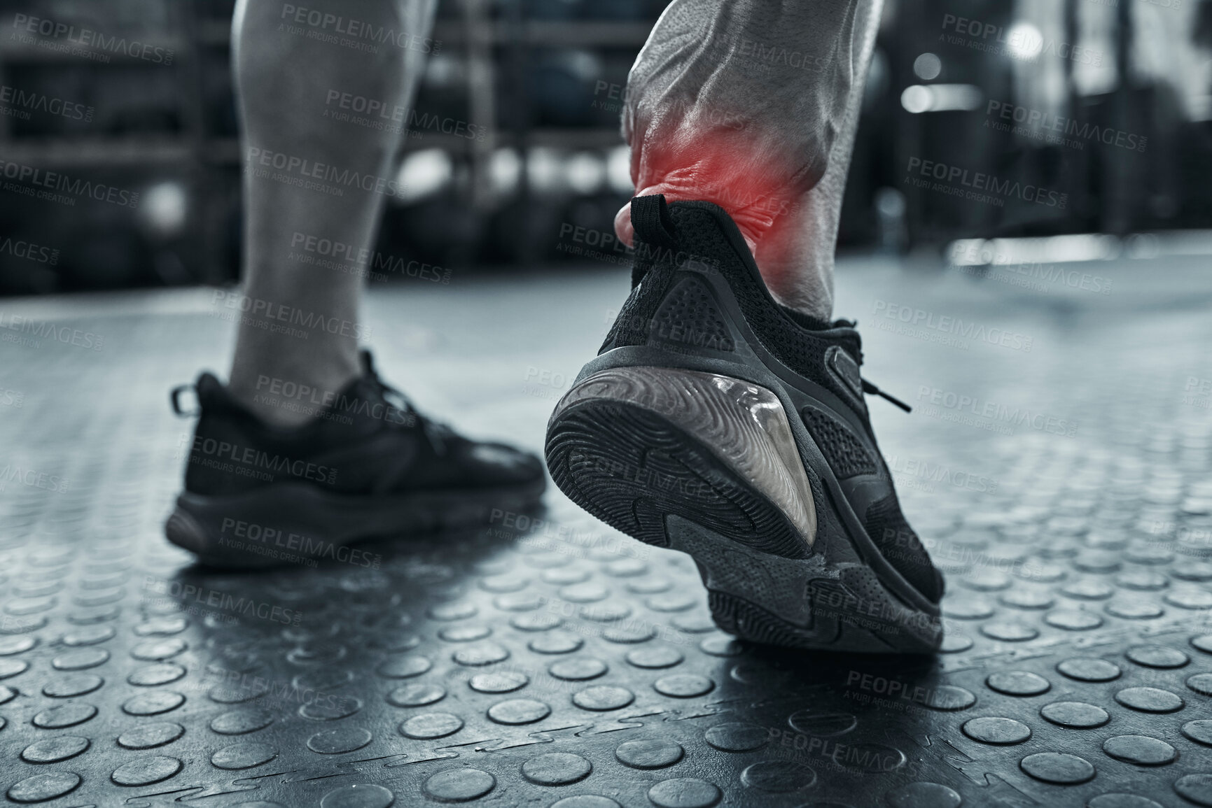 Buy stock photo Ankle pain, fitness and injury with athlete on floor of gym for accident, fail or mistake in black and white. Anatomy, back and emergency with red highlight on joint of hurt person in workout