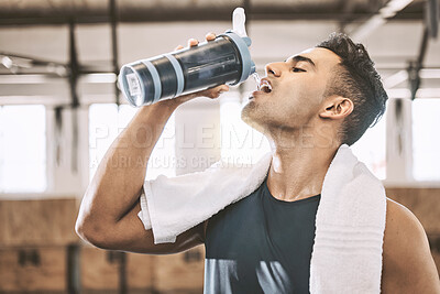 Buy stock photo Drinking water, gym and man in workout, fitness and athlete with hydration, towel and break for liquid. Healthy, rest and person with bottle, exercise and bodybuilder with wellness, sporty and club