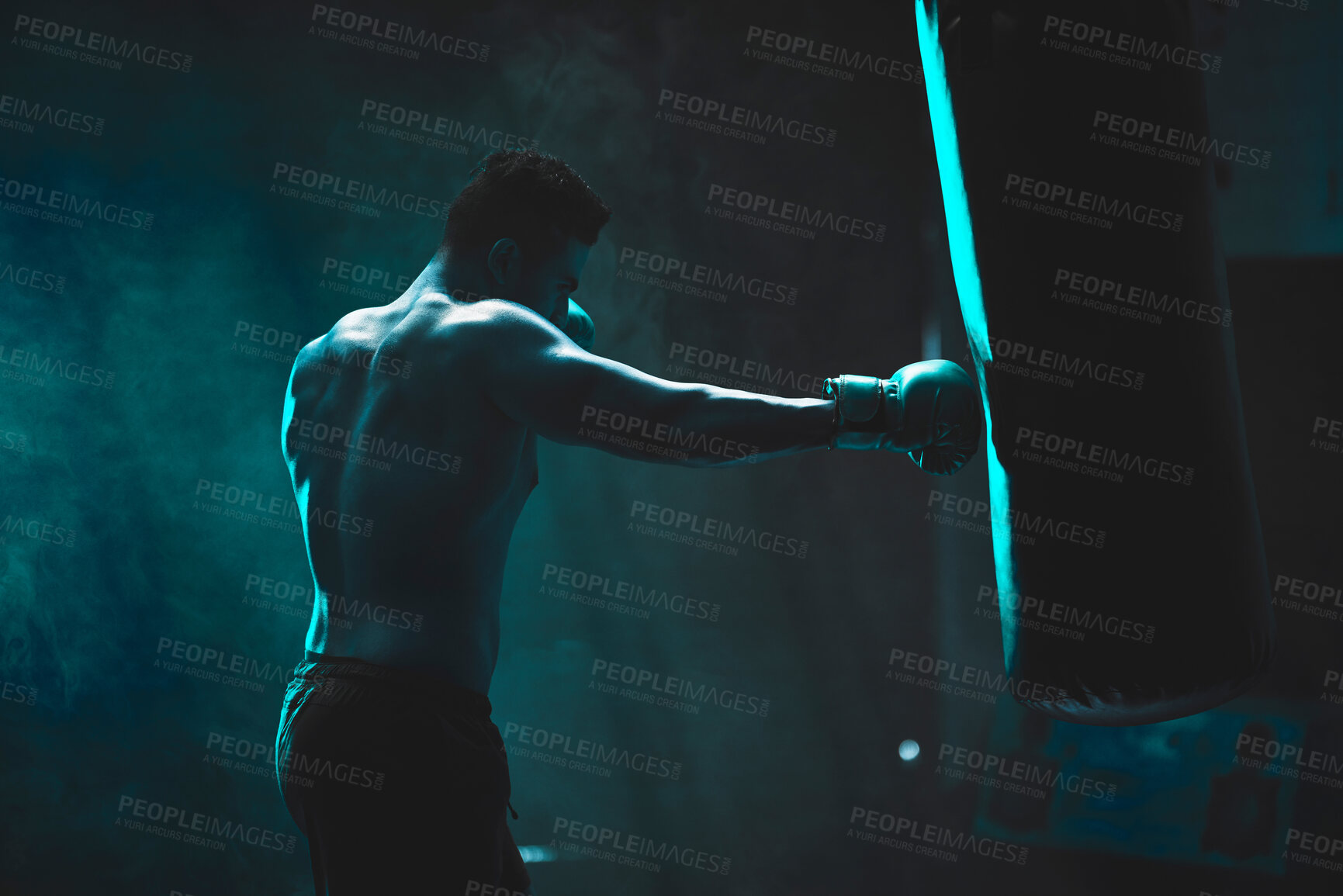 Buy stock photo Man, punching bag and boxing exercise at gym, training practice and attack challenge for combat. Male person, neon and dojo club aesthetic for fight competition, athlete and martial arts workout