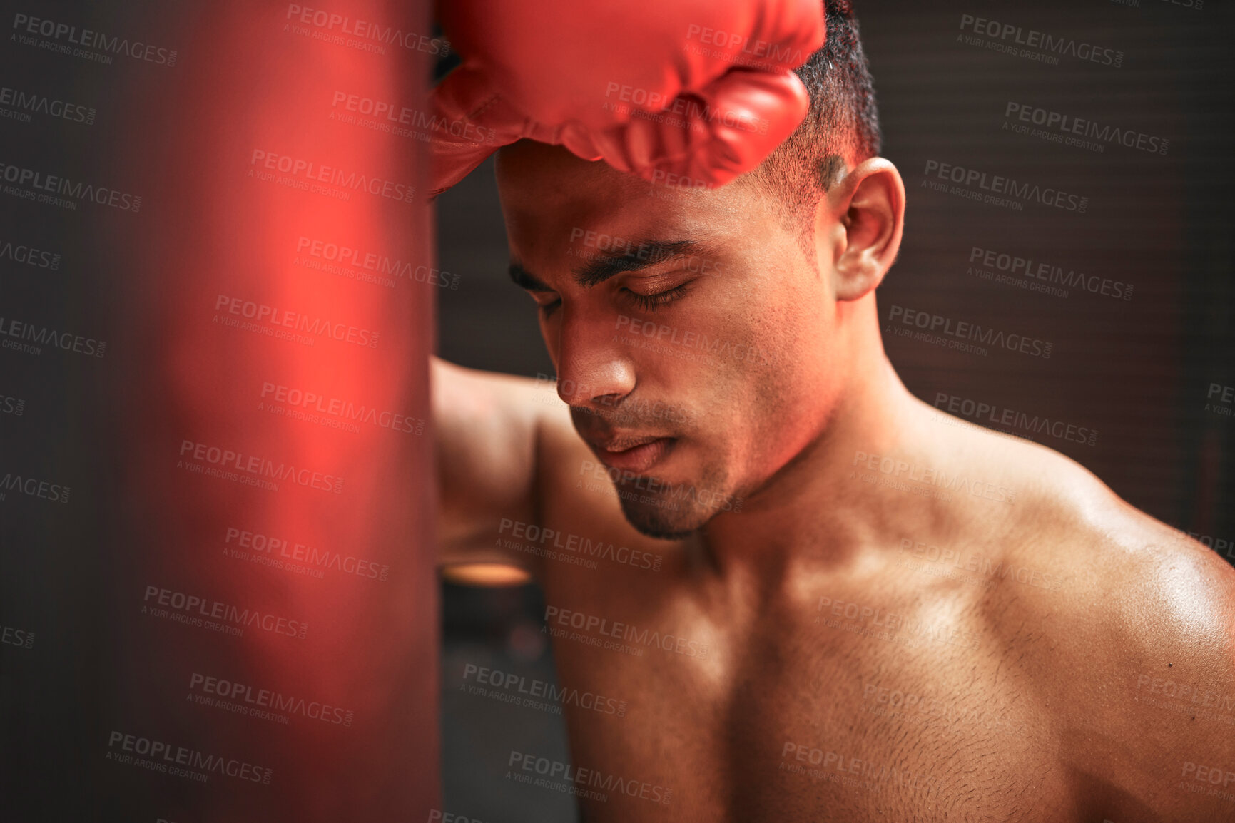 Buy stock photo Tired man, boxer and rest with punching bag for self defense training, practice or martial arts at gym. Exhausted male person or fighter in fitness for break after intense exercise or boxing match