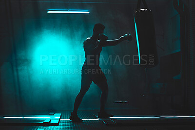 Buy stock photo Man, punching bag and strong exercise at gym, training practice and attack challenge for combat. Male person, neon and dojo club aesthetic for boxing competition, athlete and martial arts workout