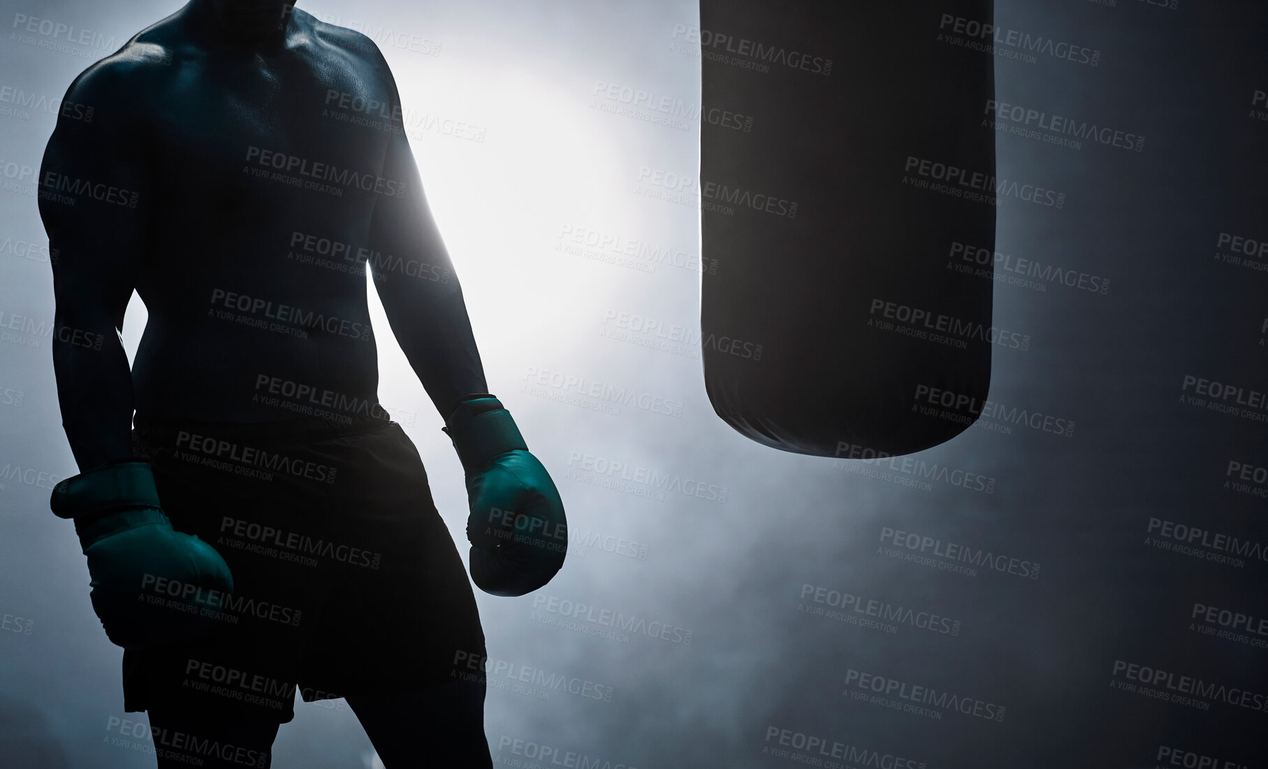 Buy stock photo Man, punching bag and silhouette exercise at gym, training practice and attack challenge for combat. Male person, smoke and dojo club aesthetic for fight competition, athlete and martial arts workout