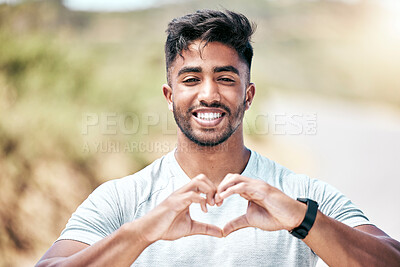 Buy stock photo Portrait, heart and man with smile, fitness and outdoor for running, healthy and workout in nature. Training, wellness and shape with fingers of athlete, person and happy for exercise in park