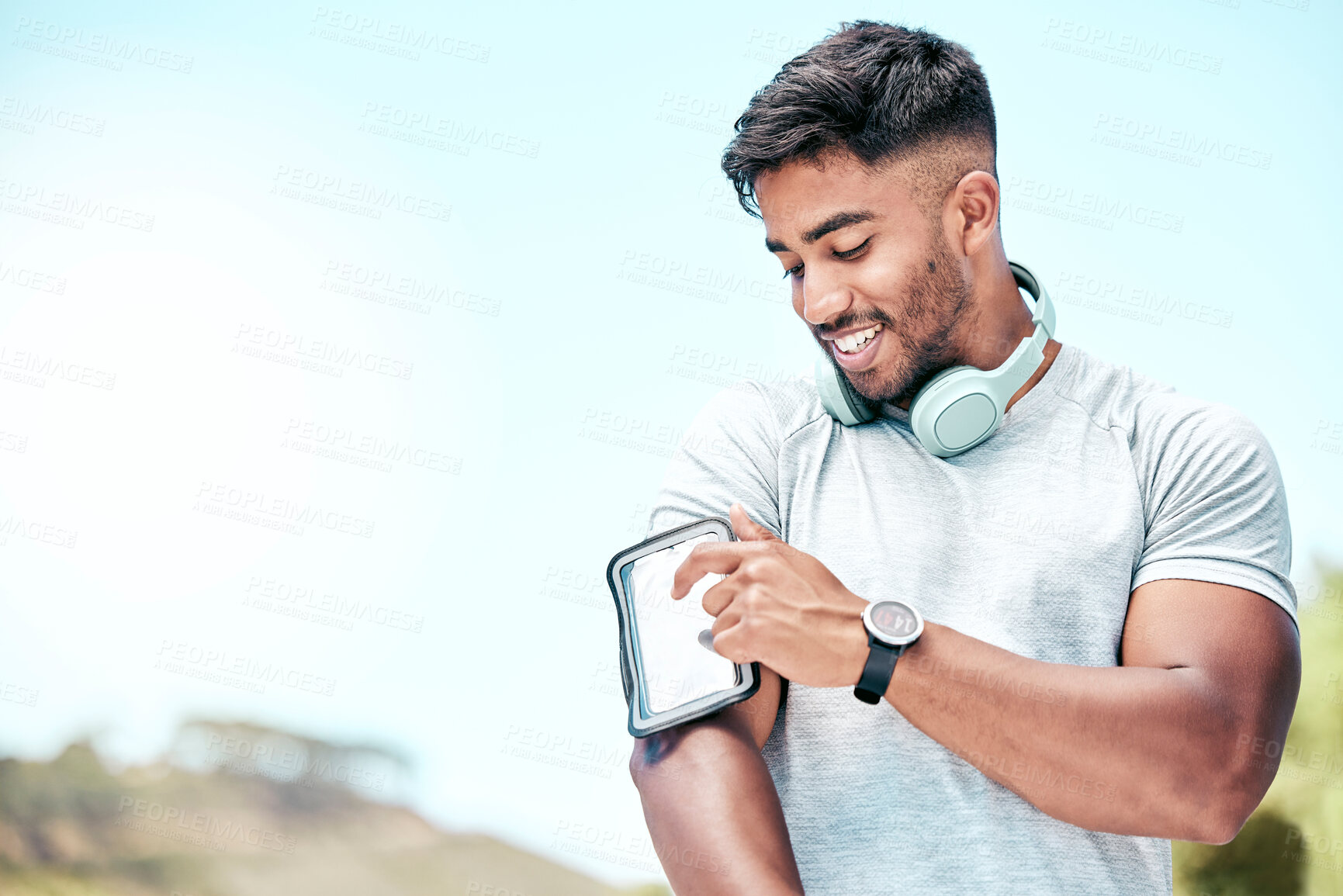 Buy stock photo Happy man, fitness and phone screen with headphones in nature for tracking performance, workout or exercise. Active or young male person with smile on mobile smartphone, training app or outdoor run