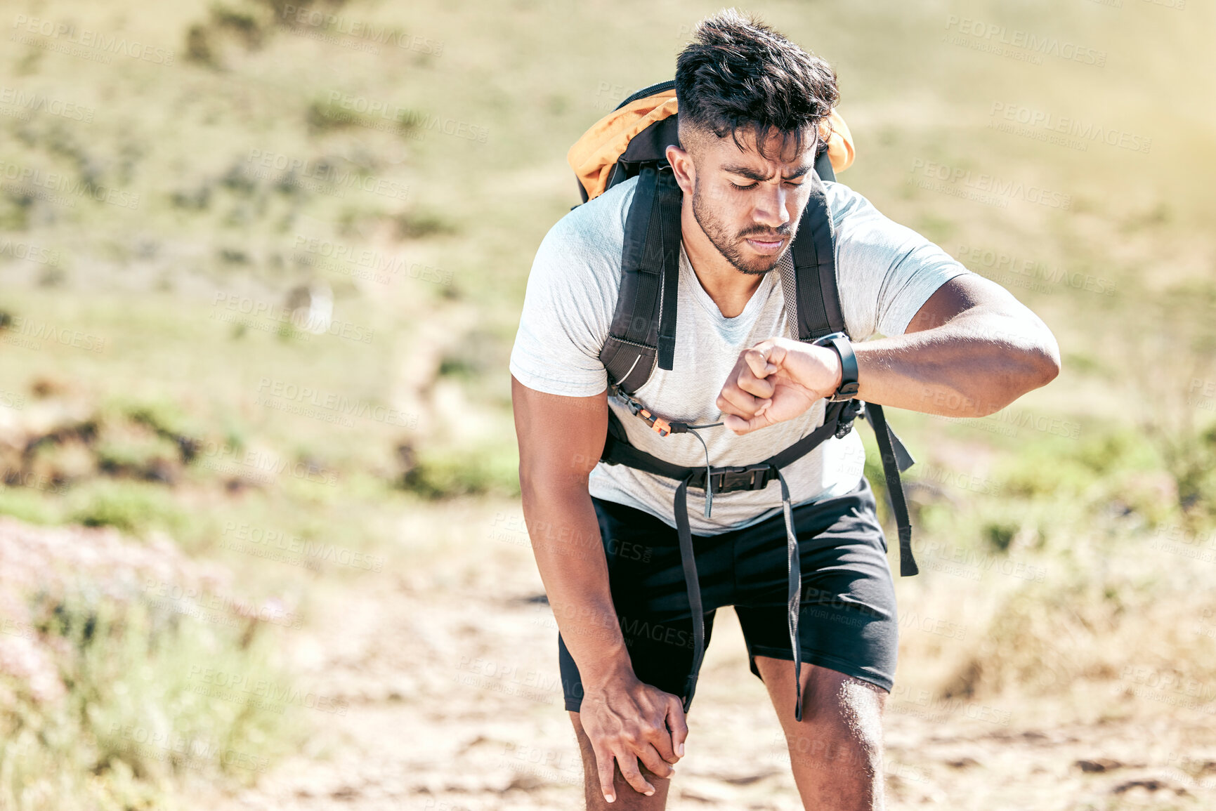 Buy stock photo Hiker, man and watch for time check on mountain peak with nature, adventure and walking outdoors on journey. Hiking, view and progress of traveler on break for goal, achievement and fitness trail