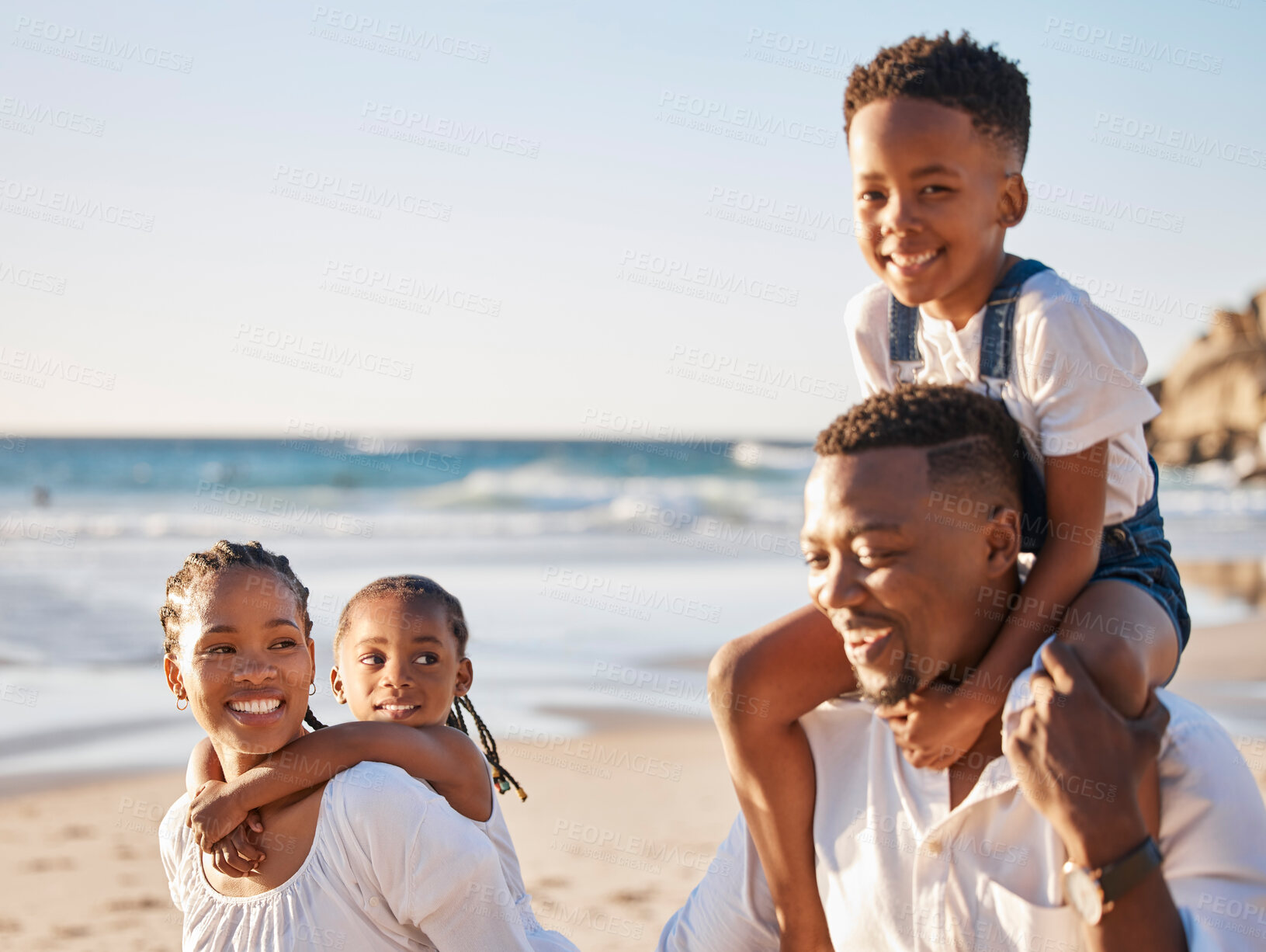 Buy stock photo Piggyback, smile and black family at beach for fun on tropical vacation, travel or getaway. Happy, bonding and portrait of African children with parents by ocean on holiday, adventure or weekend trip