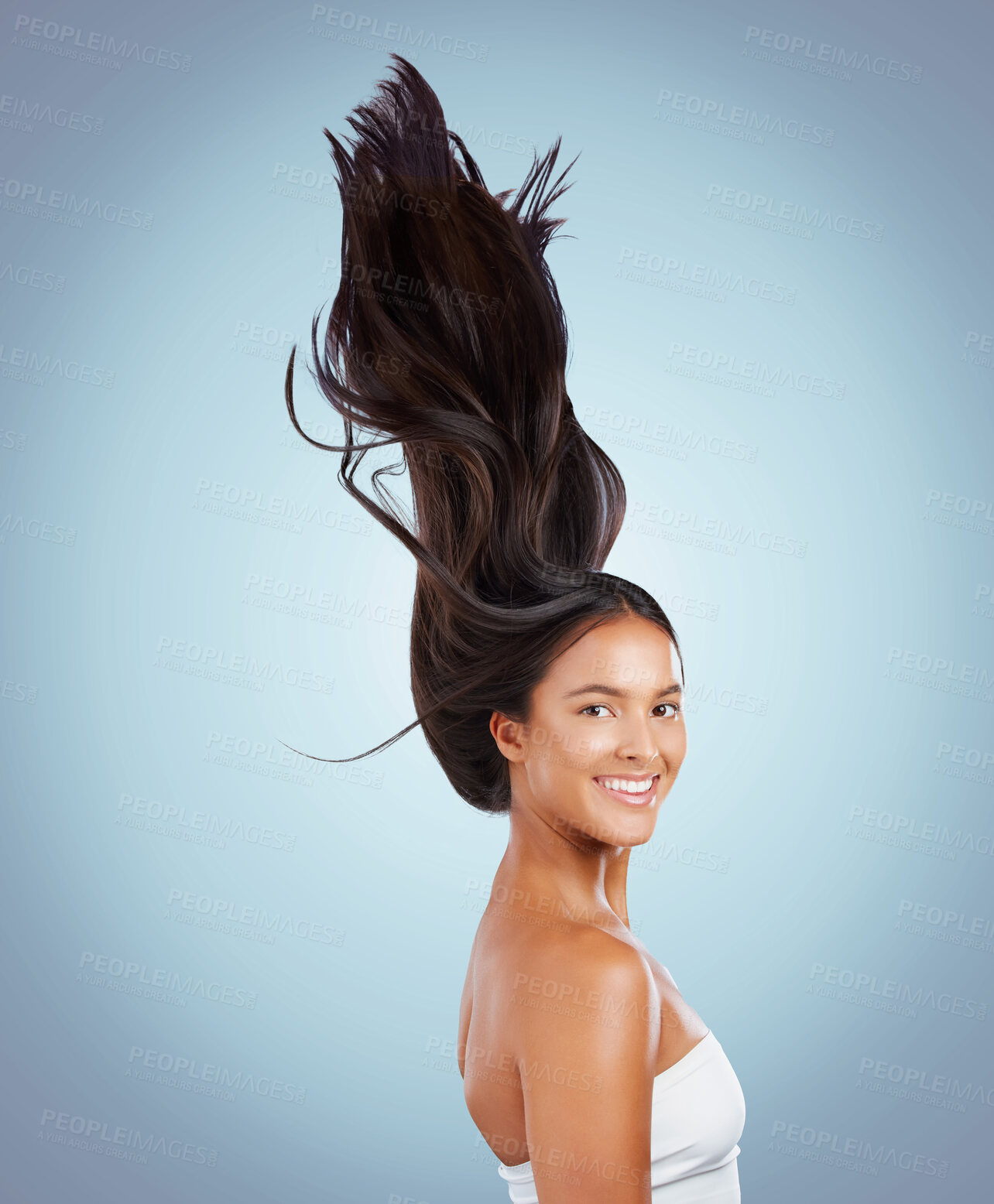 Buy stock photo Woman, movement and haircare in studio portrait, texture treatment and strong hair on blue background. Female person, growth and cosmetics shampoo or conditioner for healthy scalp, clean and wind