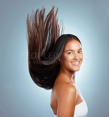 Buy stock photo Woman, motion and haircare in studio portrait, texture treatment and strong hair on blue background. Female person, growth and cosmetics shampoo or conditioner for healthy scalp, clean and smile