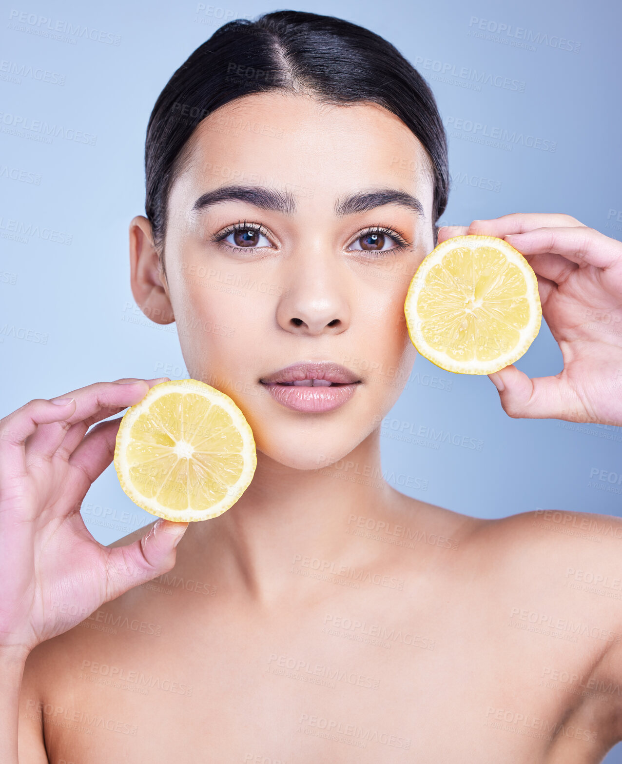 Buy stock photo Girl, lemon and portrait in studio for skincare, organic and natural cosmetic with citrus acid or vitamin c. Woman, happy and fruit on blue background for healthy glow, detox or oil control treatment