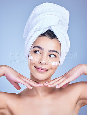 Buy stock photo Skincare, woman and cosmetics with beauty, cream and dermatology on blue studio background. Person, hands and model with towel, grooming routine and creme with treatment, wellness and healthy skin