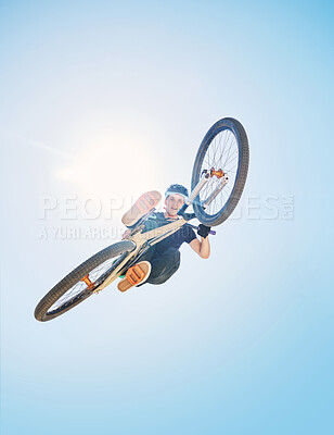 Buy stock photo Extreme sports, jump and portrait of man on bicycle for training, workout and exercise on blue sky. Fitness, cycling and low angle of person on mountain bike for adventure, freedom and adrenaline