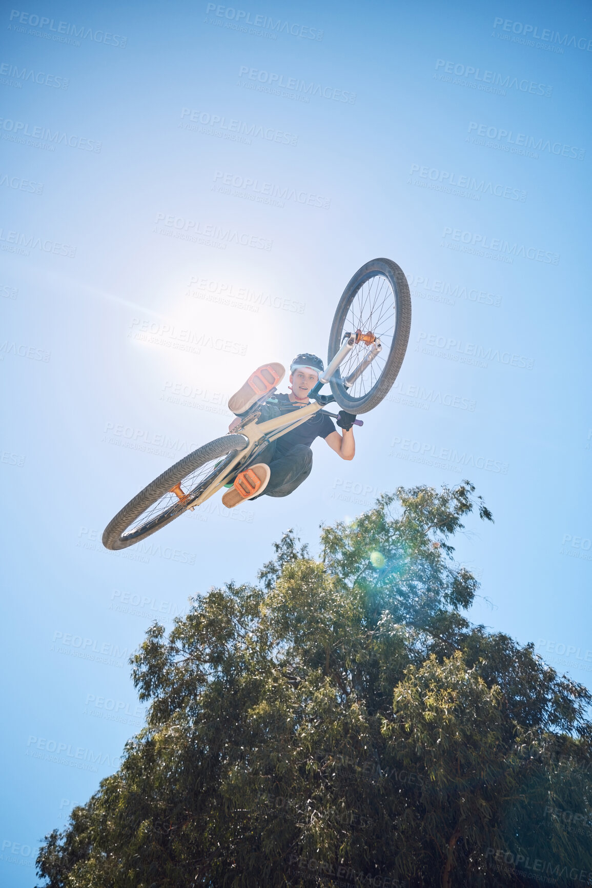 Buy stock photo Extreme sports, jump and man on bicycle in air for training, competition and exercise in countryside. Fitness, cycling and low angle of person with mountain bike for adventure, freedom and adrenaline