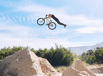 Buy stock photo Extreme sports, jump and man on bicycle on hill for training, workout and exercise in countryside. Fitness, cycling and person on mountain bike in air for adventure, freedom and adrenaline on trail