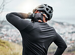 Closeup of a man suffering an injury while out cycling outside. Unknown male with an injured back. Person with a stiff, sore, problem causing him backache and discomfort. Arthritis affects posture