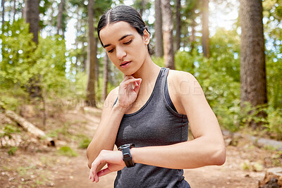 Buy stock photo Fitness, smart watch and woman in forest for running, workout and tracking intense cardio in nature. Time, performance and girl runner with sports fatigue in park stop, breathe and check heart rate