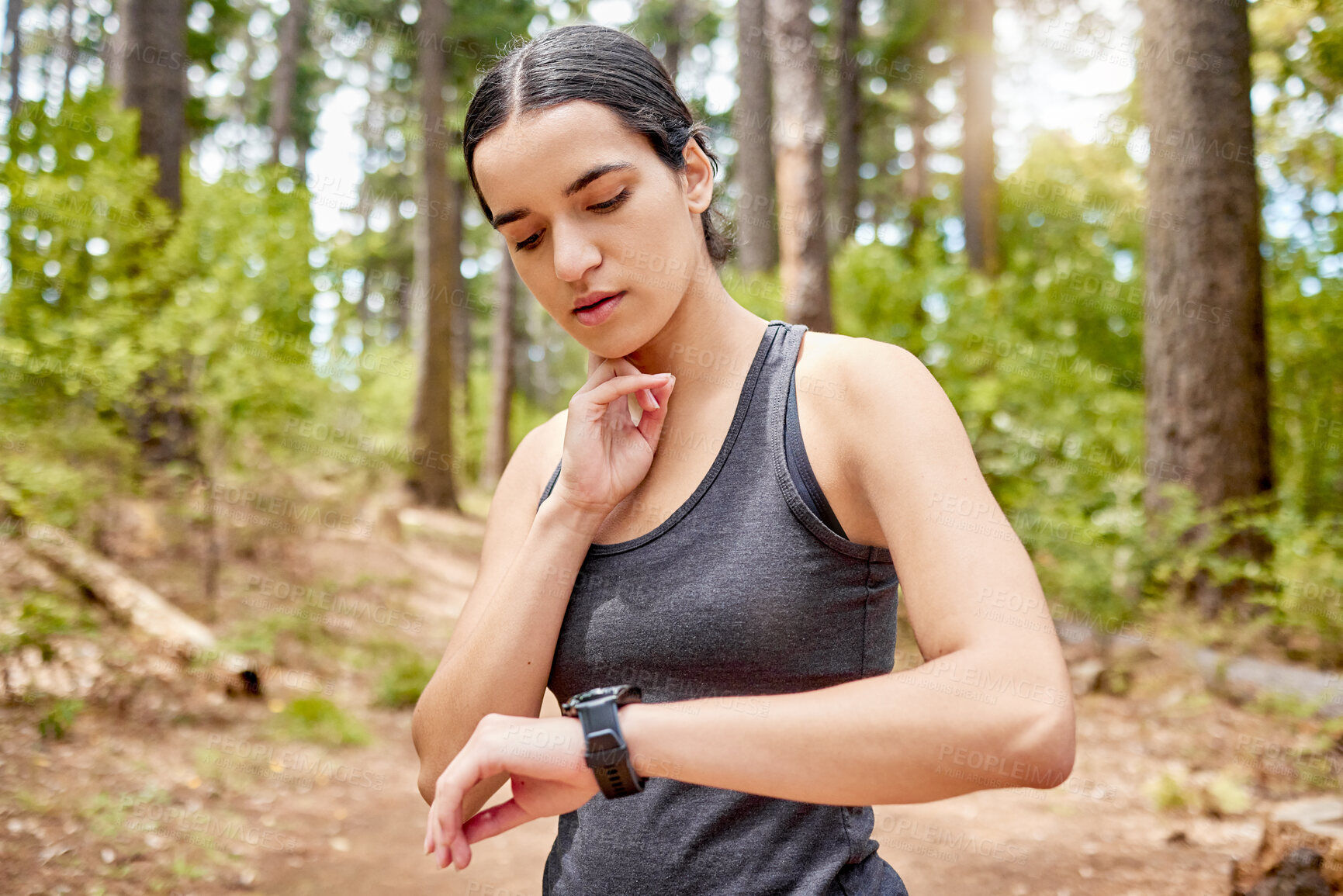 Buy stock photo Fitness, smart watch and woman in forest for running, workout and tracking intense cardio in nature. Time, performance and girl runner with sports fatigue in park stop, breathe and check heart rate