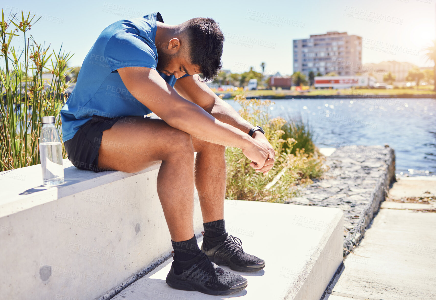 Buy stock photo Sad, tired runner or man in city on break in outdoor exercise, fitness challenge or running sports. Upset, anxiety or exhausted athlete disappointed by stress, low energy or depression in training