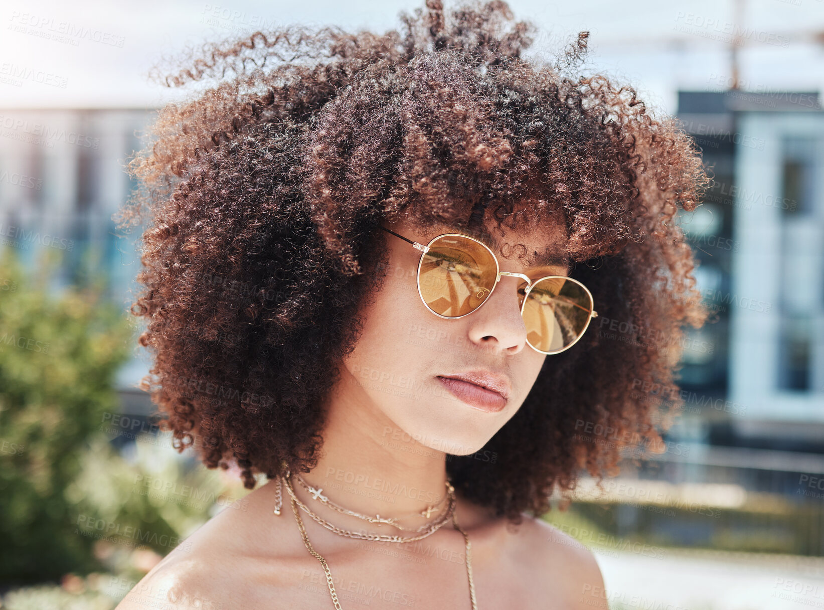 Buy stock photo Woman, portrait and accessory in outdoor for fashion, stylish or serious with confidence in Spain. City, female person or curly hair with trendy sunglasses on vacation, holiday or pride for cool look