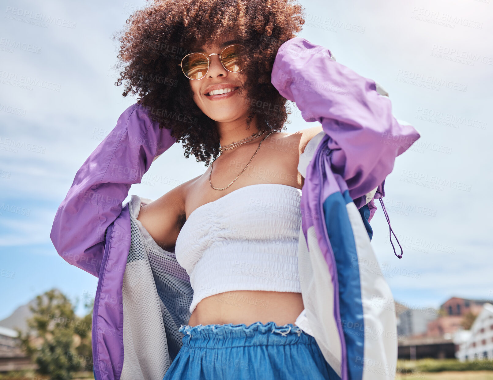 Buy stock photo Woman, portrait and edgy in city for fashion, stylish and cool with confidence in Spain. Outdoor, female person and curly hair with trendy sunglasses on vacation, holiday and hipster for accessory