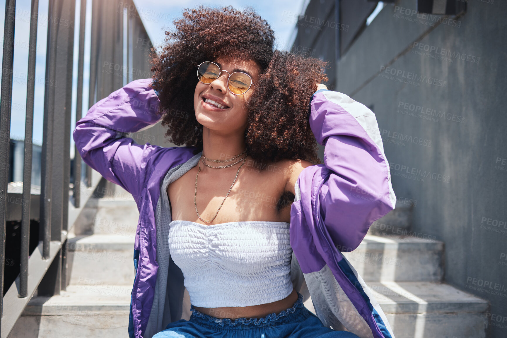 Buy stock photo Stairs, trendy and woman in portrait for fashion, stylish and hipster with confidence in Spain. Outdoor, female person and curly hair with cool sunglasses on vacation, holiday and smile in city