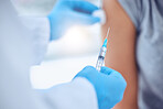 Doctor preparing a patient for injection. Caring doctor holding a needle filled with covid vaccine cropped. Hand of physician holding a syringe of antidote. Patient in a checkup for an injection