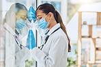 Young stressed and overworked doctor wearing mask and gloves while standing at a window in a hospital or clinic. One female only looking worried, hopeless and anxious while struggling with a challenge